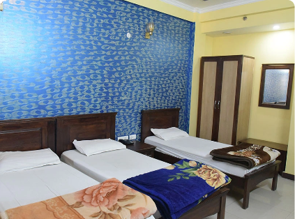 Triple-bed guest room at Patanjali Wellness for Ayurveda and yoga retreat accommodation